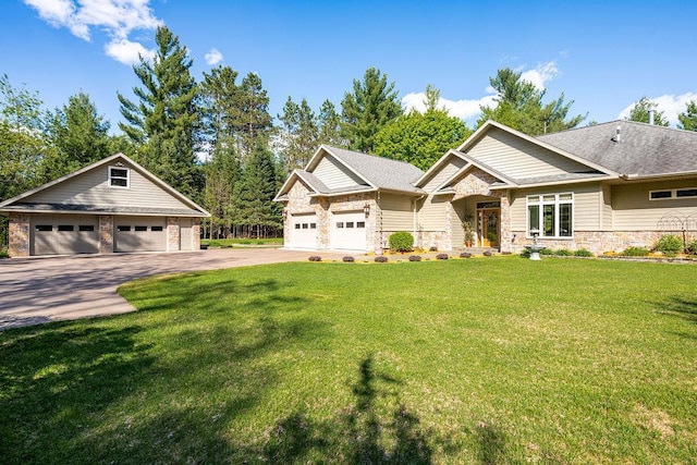 79394 Long Lake Rd, Kettle River Twp, MN 55795 - craftsman-style house with stone siding, a garage, an outbuilding, and a front yard