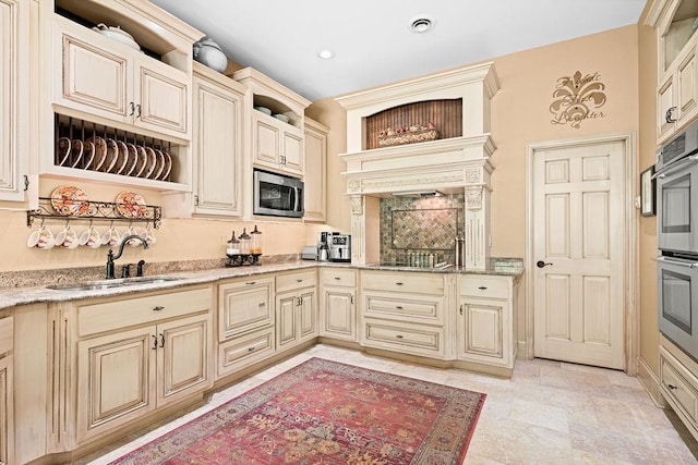79394 Long Lake Rd, Kettle River Twp, MN 55795 - kitchen with cream cabinetry, a sink, appliances with stainless steel finishes, and recessed lighting