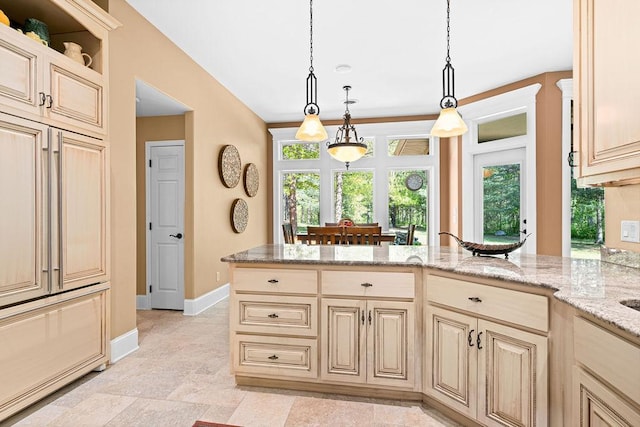 79394 Long Lake Rd, Kettle River Twp, MN 55795 - kitchen featuring baseboards, cream cabinets, light stone countertops, hanging light fixtures, and a peninsula