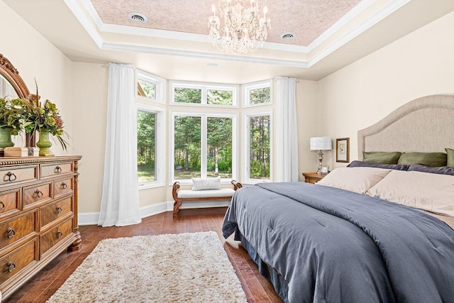 79394 Long Lake Rd, Kettle River Twp, MN 55795 - bedroom with a tray ceiling, crown molding, dark wood finished floors, a chandelier, and baseboards