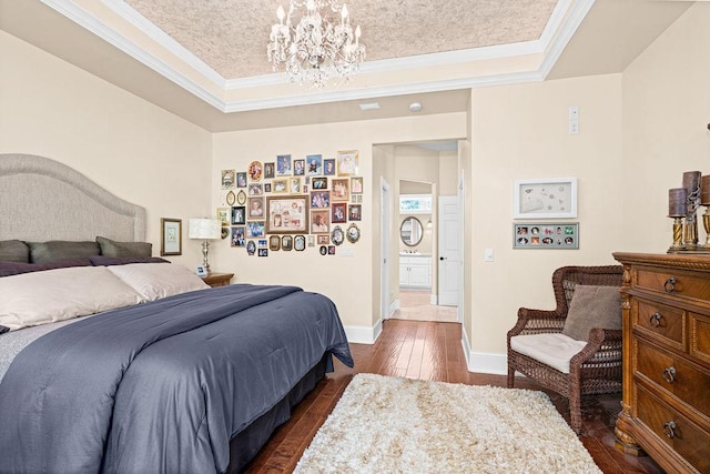 79394 Long Lake Rd, Kettle River Twp, MN 55795 - bedroom featuring a raised ceiling, a chandelier, dark wood-style flooring, crown molding, and baseboards