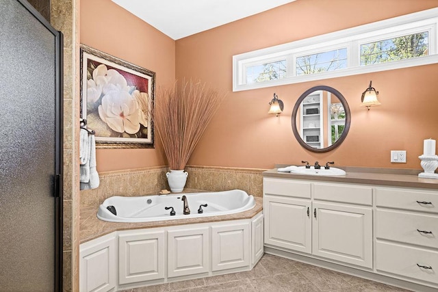 79394 Long Lake Rd, Kettle River Twp, MN 55795 - full bathroom featuring vanity, a garden tub, and tile patterned flooring