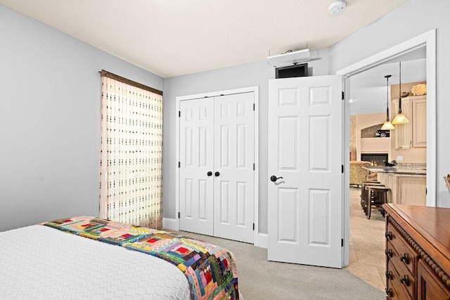 79394 Long Lake Rd, Kettle River Twp, MN 55795 - bedroom featuring a warm lit fireplace and a closet