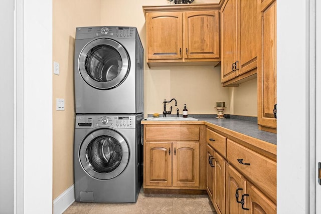 79394 Long Lake Rd, Kettle River Twp, MN 55795 - laundry room featuring stacked washer / dryer, cabinet space, and baseboards