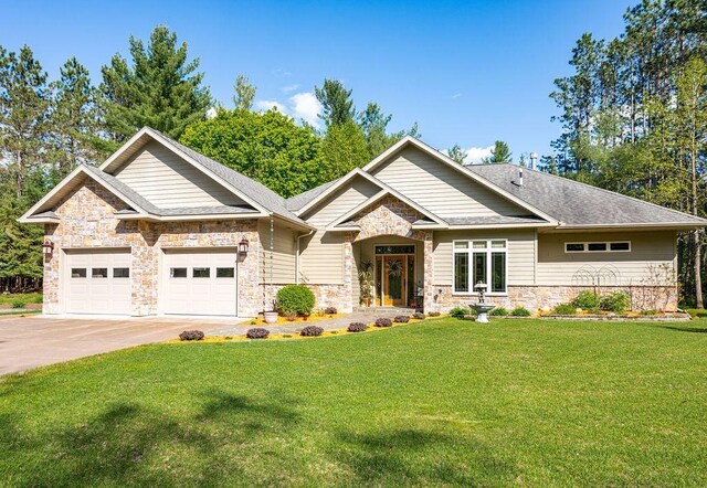 79394 Long Lake Rd, Kettle River Twp, MN 55795 - craftsman house featuring stone siding, a garage, a front lawn, and driveway