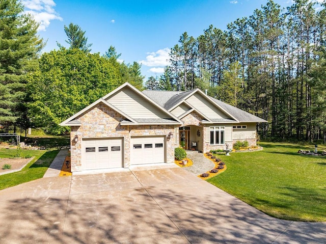 79394 Long Lake Rd, Kettle River Twp, MN 55795 - view of front facade featuring stone siding, a front lawn, driveway, and a garage