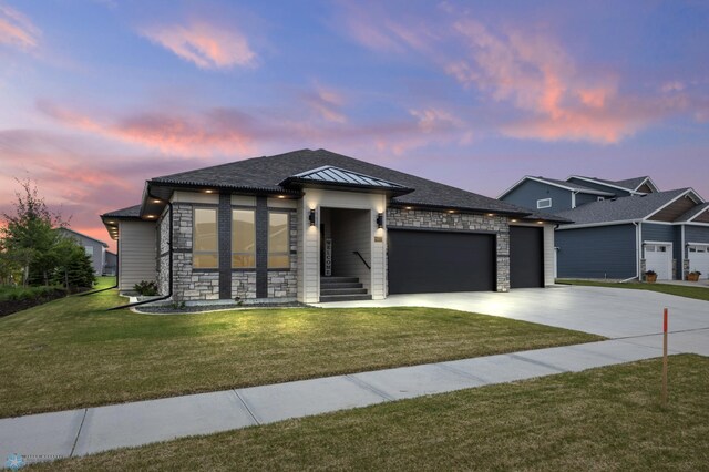 7886 Firefly Ln, Horace, ND 58047 - view of front of home featuring stone siding, an attached garage, driveway, and a yard