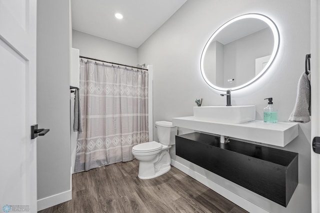 7886 Firefly Ln, Horace, ND 58047 - bathroom featuring toilet, wood finished floors, vanity, a shower with curtain, and recessed lighting