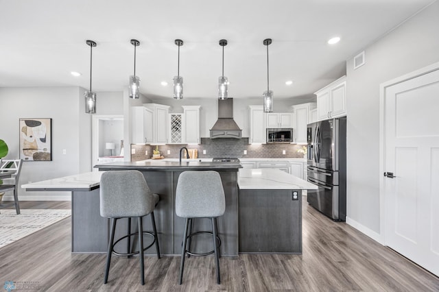 7886 Firefly Ln, Horace, ND 58047 - kitchen featuring stainless steel appliances, custom exhaust hood, decorative backsplash, dark wood-type flooring, and recessed lighting