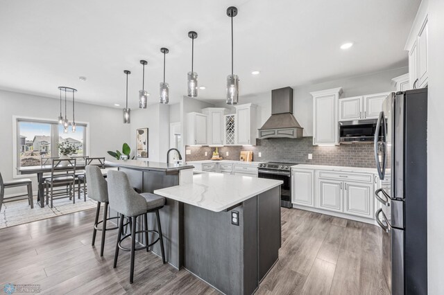 7886 Firefly Ln, Horace, ND 58047 - kitchen featuring appliances with stainless steel finishes, custom range hood, white cabinets, and recessed lighting