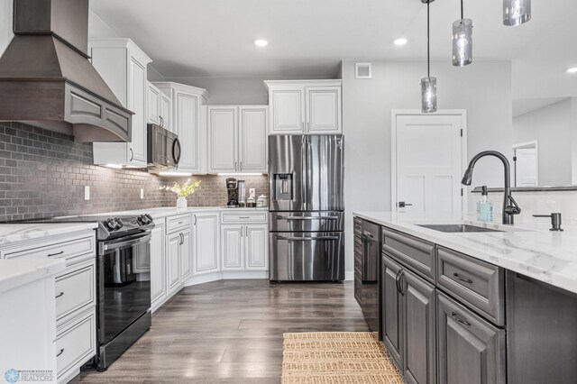 7886 Firefly Ln, Horace, ND 58047 - kitchen featuring stainless steel fridge, black electric range oven, wall chimney exhaust hood, a sink, and white cabinetry