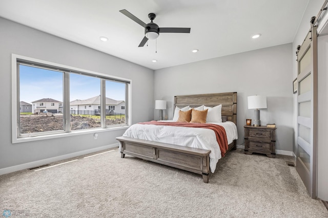 7886 Firefly Ln, Horace, ND 58047 - bedroom featuring a barn door, light carpet, baseboards, recessed lighting, and ceiling fan