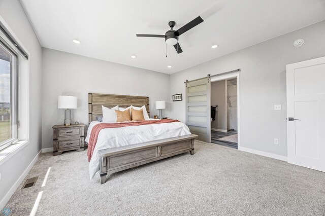 7886 Firefly Ln, Horace, ND 58047 - bedroom featuring a barn door, carpet floors, baseboards, recessed lighting, and ceiling fan