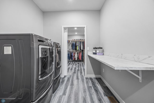 7886 Firefly Ln, Horace, ND 58047 - laundry room featuring independent washer and dryer, wood finished floors, and baseboards