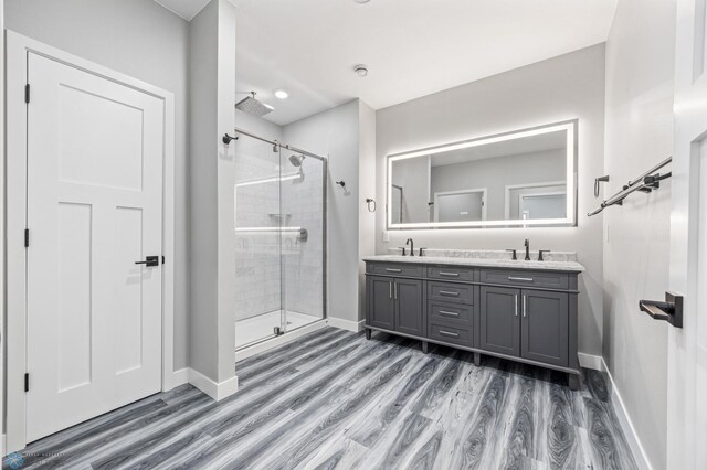 7886 Firefly Ln, Horace, ND 58047 - full bath with a shower stall, double vanity, wood finished floors, and baseboards