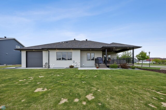 7886 Firefly Ln, Horace, ND 58047 - back of house featuring a yard, an attached garage, and ceiling fan