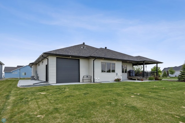 7886 Firefly Ln, Horace, ND 58047 - back of house featuring a yard, a shingled roof, a garage, and cooling unit