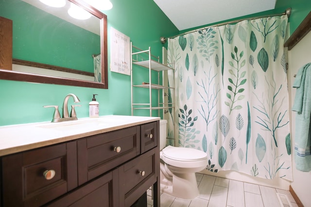 308 18th Ave NE, Waseca, MN 56093 - full bathroom with vanity, toilet, a shower with curtain, and tile patterned flooring