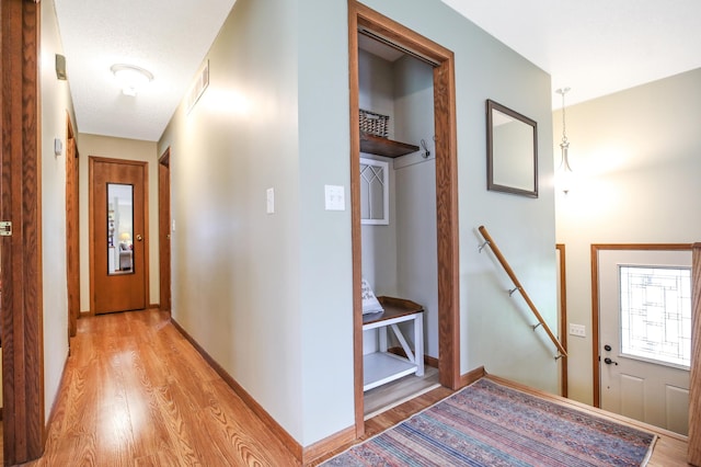 308 18th Ave NE, Waseca, MN 56093 - hall featuring light wood-style floors, an upstairs landing, and baseboards
