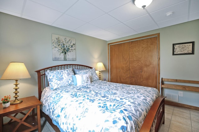 308 18th Ave NE, Waseca, MN 56093 - bedroom featuring a drop ceiling, a closet, and light tile patterned floors