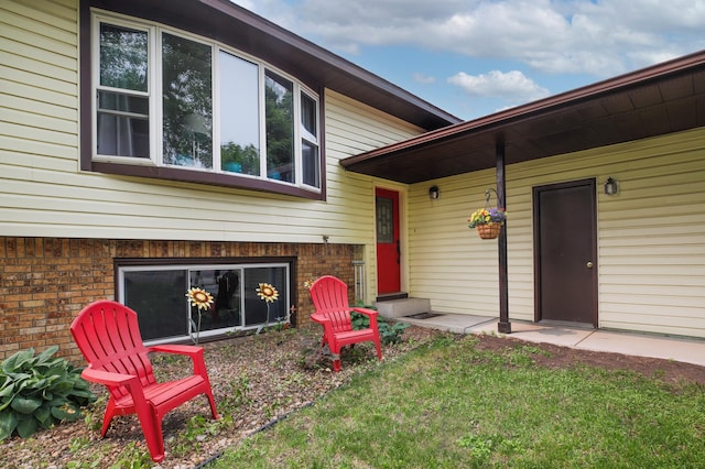 308 18th Ave NE, Waseca, MN 56093 - property entrance with brick siding and a lawn