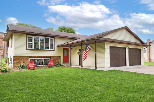 308 18th Ave NE, Waseca, MN 56093 - view of front of home with an attached garage, a front yard, concrete driveway, brick siding, and roof with shingles