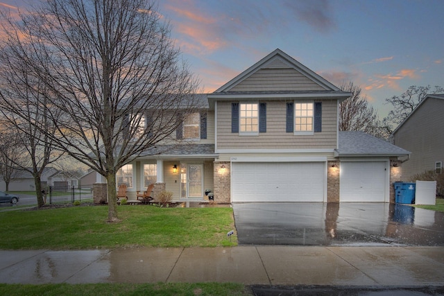 10542 188th Ave NW, Elk River, MN 55330 - traditional-style house featuring driveway, a front yard, brick siding, and a garage