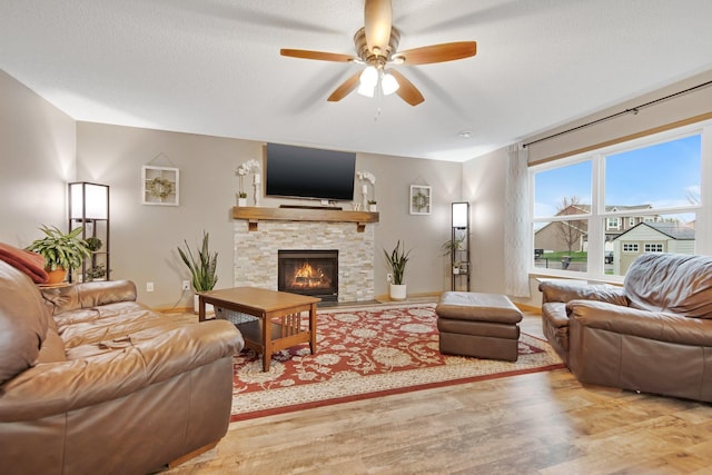 10542 188th Ave NW, Elk River, MN 55330 - living room with wood finished floors, a ceiling fan, and a fireplace