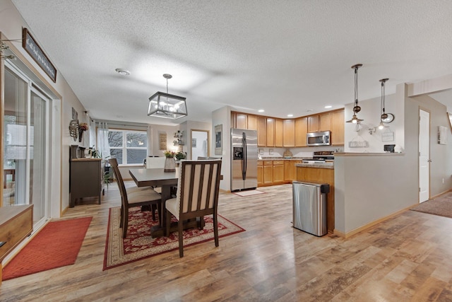 10542 188th Ave NW, Elk River, MN 55330 - dining space featuring a textured ceiling, light wood-style floors, a chandelier, baseboards, and recessed lighting