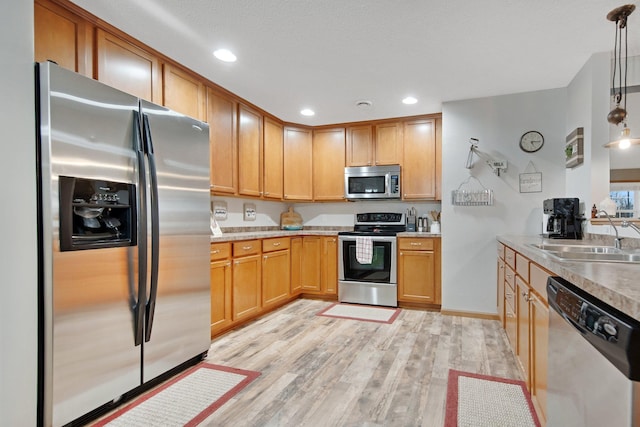 10542 188th Ave NW, Elk River, MN 55330 - kitchen featuring stainless steel appliances, a sink, light wood finished floors, light countertops, and recessed lighting
