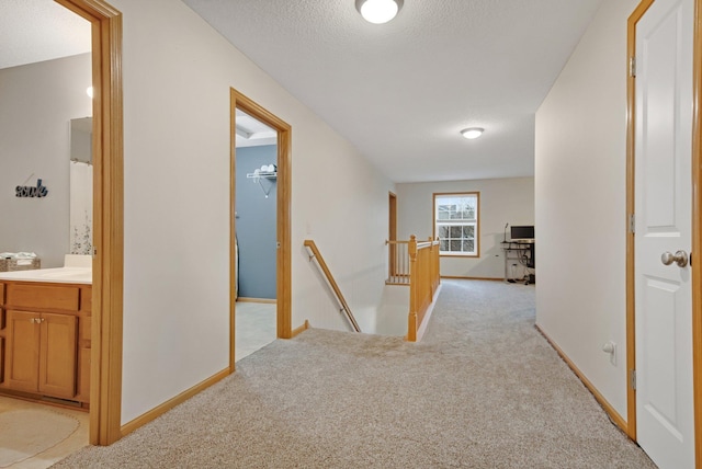 10542 188th Ave NW, Elk River, MN 55330 - hallway featuring an upstairs landing, light carpet, baseboards, and a textured ceiling