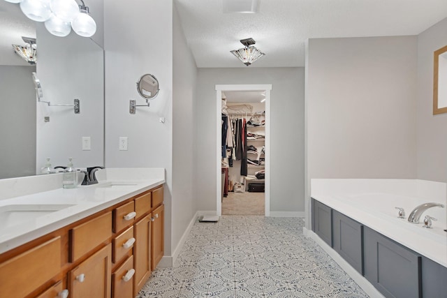 10542 188th Ave NW, Elk River, MN 55330 - full bath featuring double vanity, a bath, baseboards, a spacious closet, and a textured ceiling