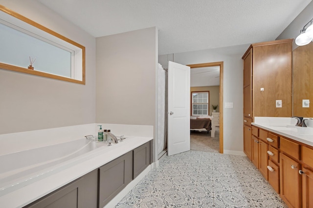 10542 188th Ave NW, Elk River, MN 55330 - ensuite bathroom with vanity, a shower stall, a garden tub, and baseboards