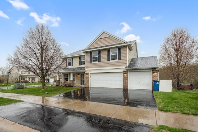 10542 188th Ave NW, Elk River, MN 55330 - view of front facade featuring asphalt driveway, brick siding, a front lawn, an attached garage, and a shingled roof