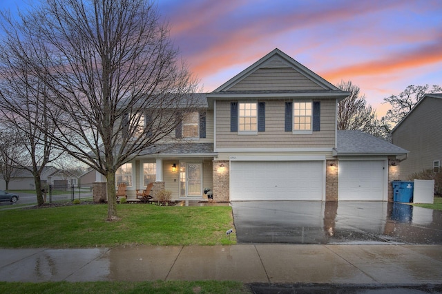 10542 188th Ave NW, Elk River, MN 55330 - traditional-style house featuring driveway, a front lawn, brick siding, and a garage