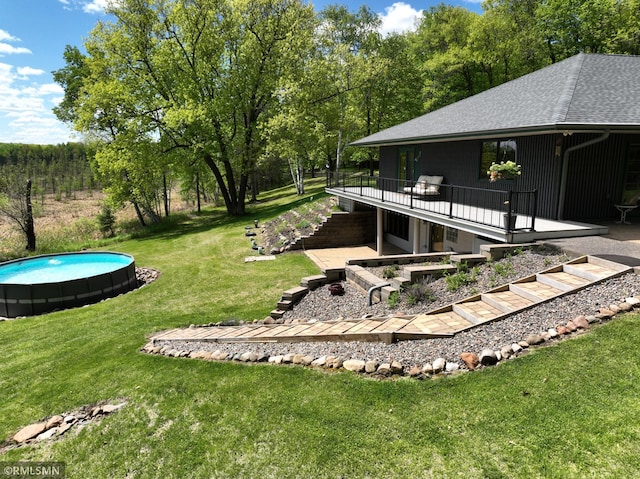 3004 370th Ave, Sandstone, MN 55072 - view of green lawn with stairway, a wooden deck, an outdoor pool, and a patio area