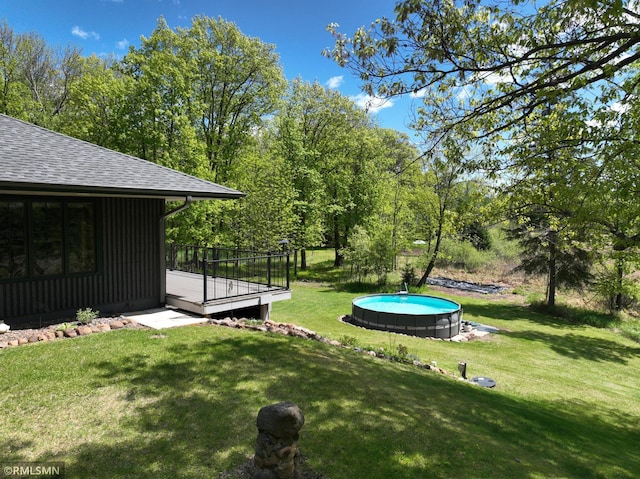 3004 370th Ave, Sandstone, MN 55072 - view of grassy yard featuring a wooden deck and an outdoor pool
