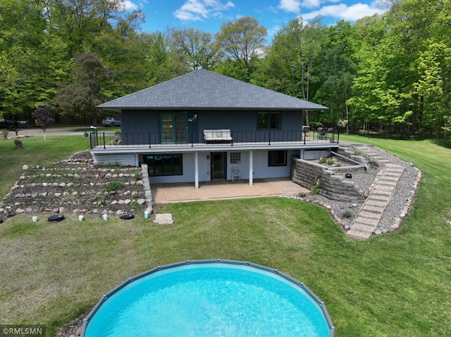3004 370th Ave, Sandstone, MN 55072 - rear view of house featuring a patio, a wooden deck, roof with shingles, and a yard