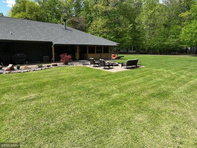 3004 370th Ave, Sandstone, MN 55072 - view of green lawn featuring an outdoor fire pit and a patio area