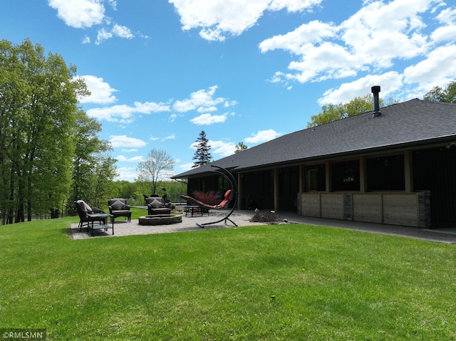 3004 370th Ave, Sandstone, MN 55072 - back of property with an outdoor fire pit, a lawn, roof with shingles, and a patio area
