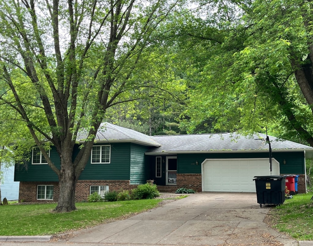 1430 48th Ave, Goodview, MN 55987 - tri-level home with a garage, concrete driveway, and a front lawn