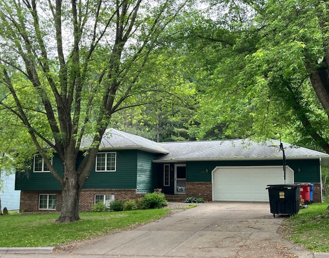 1430 48th Ave, Goodview, MN 55987 - tri-level home with a garage, concrete driveway, and a front lawn