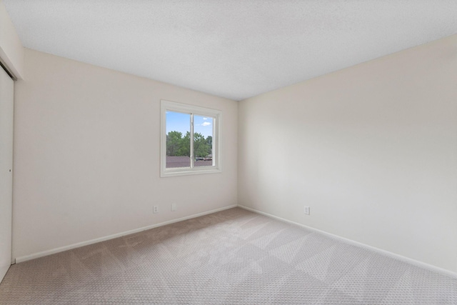 5707 80th Ave N, Brooklyn Park, MN 55443 - unfurnished bedroom featuring carpet floors, baseboards, and a closet