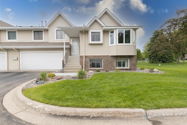 9309 Loch Lomond Ln, Brooklyn Park, MN 55443 - raised ranch with a front yard, a garage, brick siding, and driveway