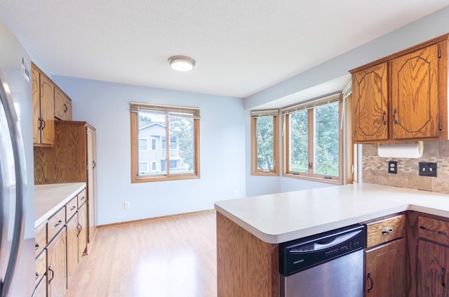 9309 Loch Lomond Ln, Brooklyn Park, MN 55443 - kitchen featuring appliances with stainless steel finishes, plenty of natural light, light countertops, and decorative backsplash
