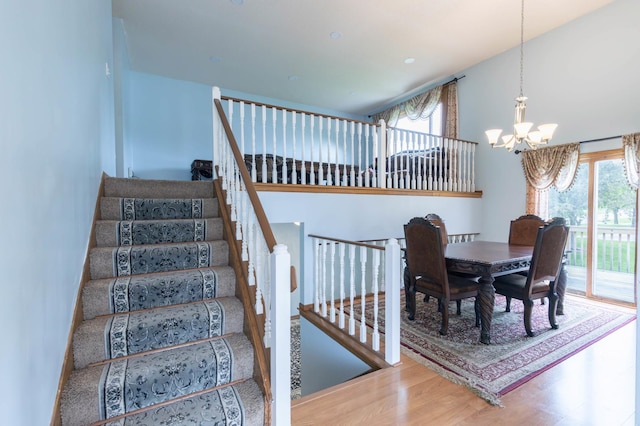 9309 Loch Lomond Ln, Brooklyn Park, MN 55443 - stairs with a chandelier and wood finished floors