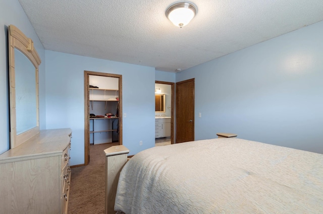 9309 Loch Lomond Ln, Brooklyn Park, MN 55443 - bedroom featuring carpet, a textured ceiling, a spacious closet, a closet, and ensuite bath
