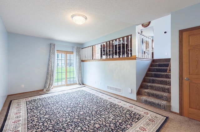 9309 Loch Lomond Ln, Brooklyn Park, MN 55443 - carpeted empty room with stairs, a textured ceiling, and baseboards