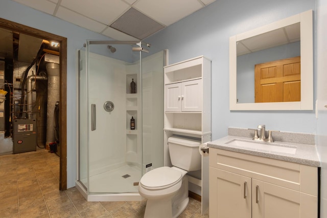 9309 Loch Lomond Ln, Brooklyn Park, MN 55443 - full bathroom featuring vanity, a stall shower, toilet, a paneled ceiling, and heating unit