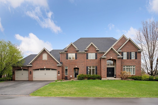 330 Lythrum Ln, Medina, MN 55340 - view of front of home with driveway, a front yard, a garage, and brick siding